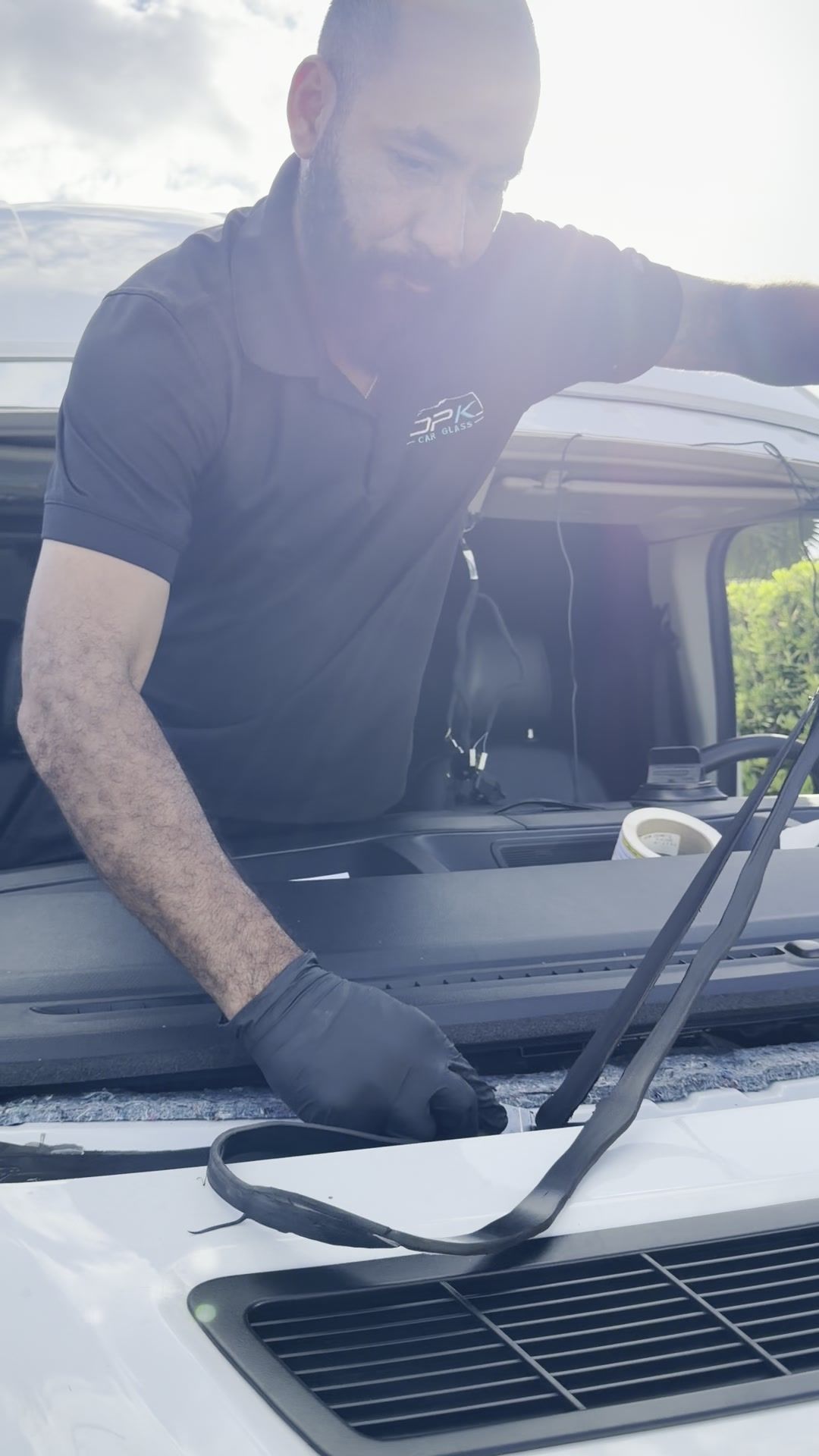 Technician preparing the windshield frame on the car