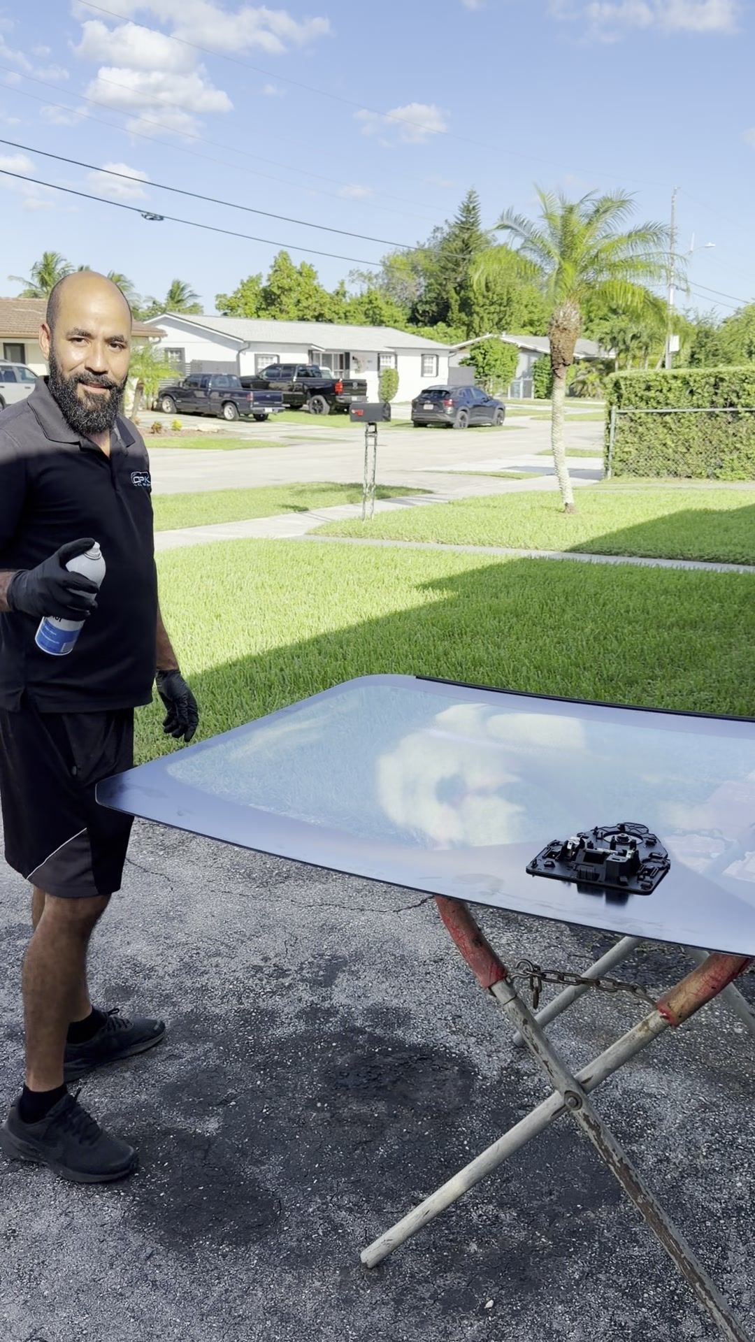 OPK technician next to a new windshield ready to install