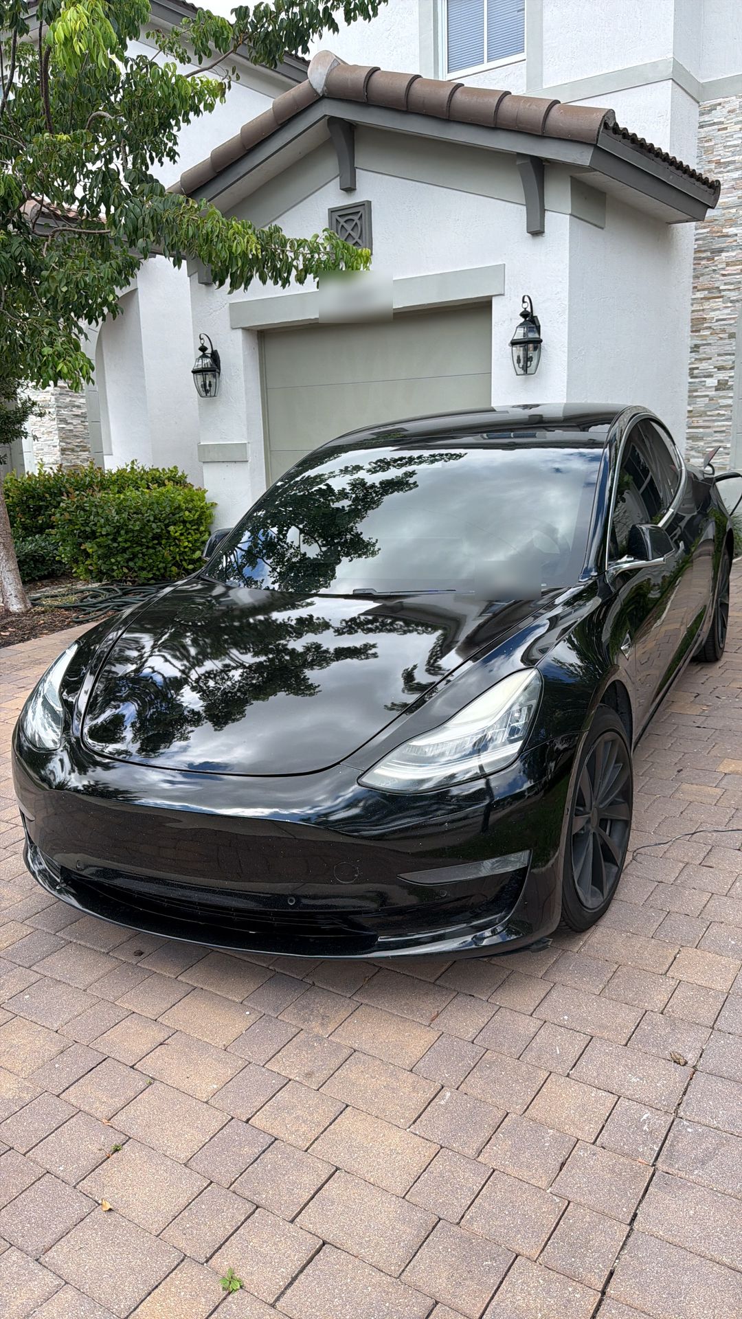 Black Tesla Model 3 before the windshield replacement